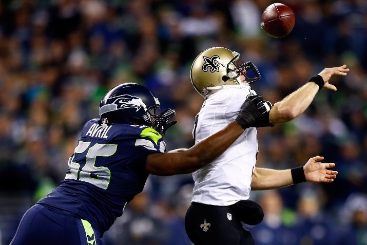 SEATTLE, WA - DECEMBER 02: Defensive end Cliff Avril #56 of the Seattle Seahawks knocks the ball from quarterback Drew Brees #9 of the New Orleans Saints in the first quarter during a game at CenturyLink Field on December 2, 2013 in Seattle, Washington. (Photo by Jonathan Ferrey/Getty Images)