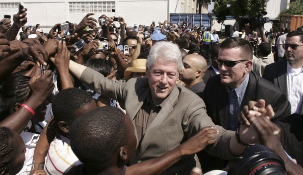 Former U.S. President Clinton greets Haitians during his visit to a U.N. base in Port-au-Prince