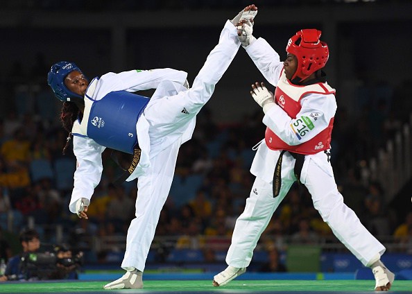 France's Haby Niare (L) competes against Haiti's Aniya Necol Louissaint during their womens taekwondo qualifying bout in the -67kg category as part of the Rio 2016 Olympic Games, on August 19, 2016, at the Carioca Arena 3, in Rio de Janeiro. / AFP / Kirill KUDRYAVTSEV (Photo credit should read KIRILL KUDRYAVTSEV/AFP/Getty Images)